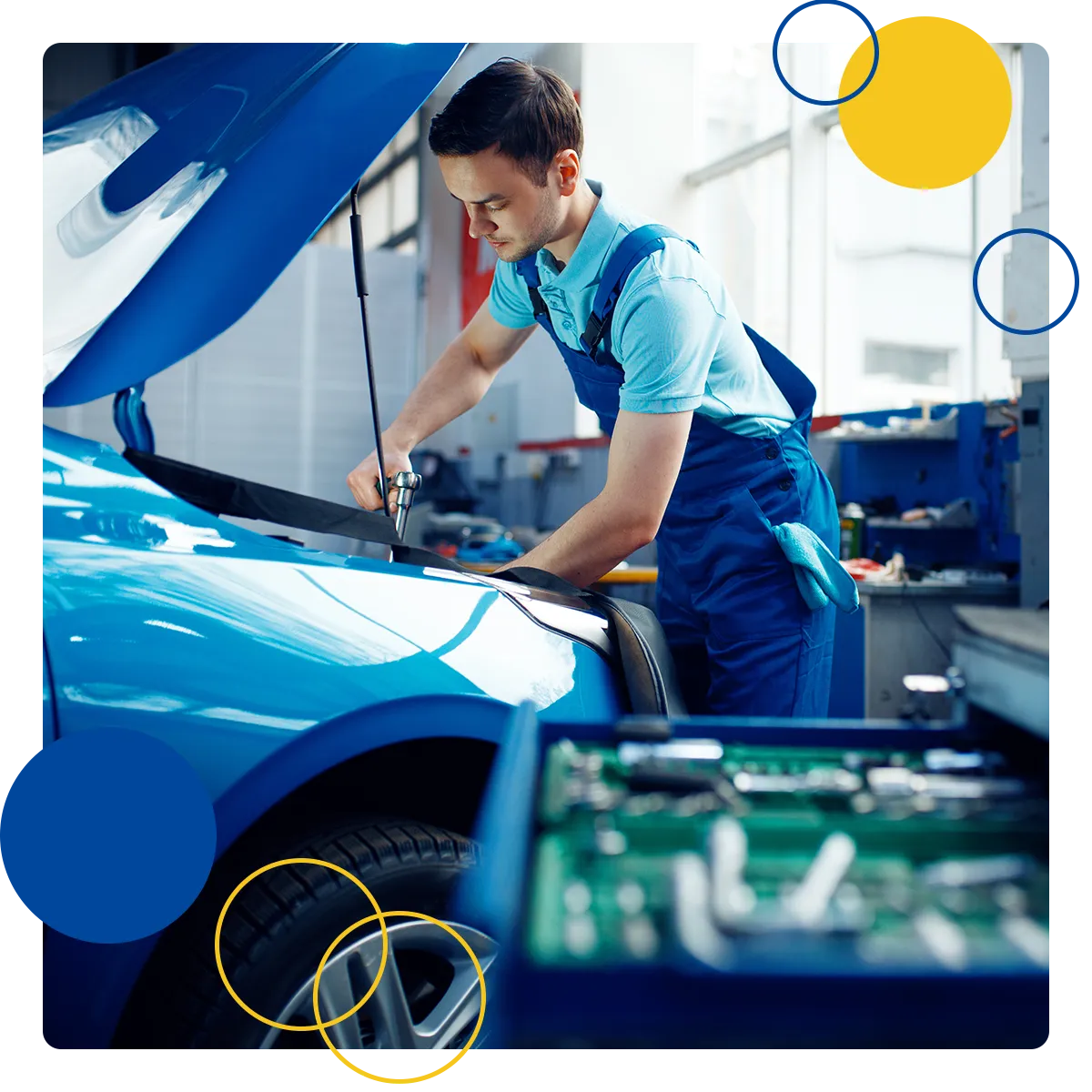 Mechanic working under the hood of a blue car
